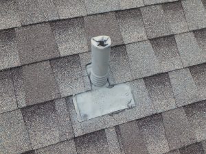 Improper lacing of a plumbing vent roof flashing.